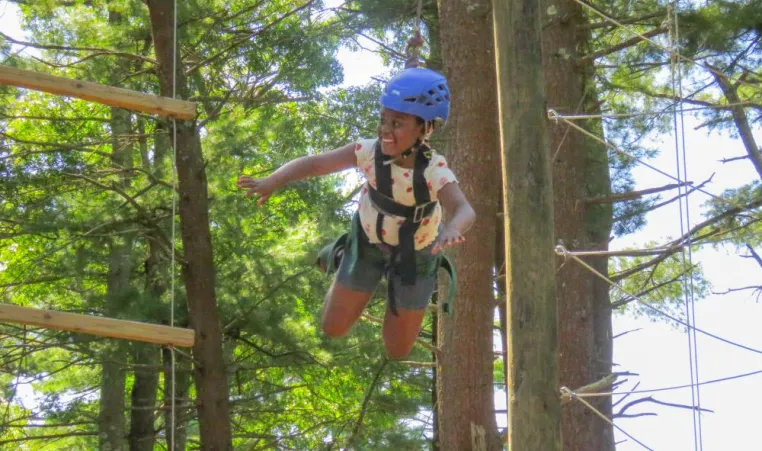 Genesis Guzman completes the rope course at Camp Yomechas by jumping from the top. Photos by Ethan Hunt