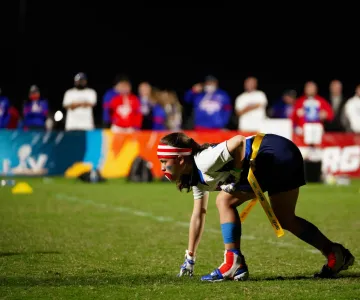 Fierce girl looking down the field ready to go in a NFL flag football game