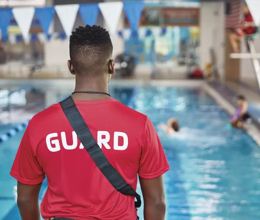 Lifeguard watching the pool to ensure safety in and around the water